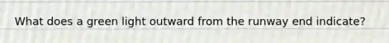 What does a green light outward from the runway end indicate?