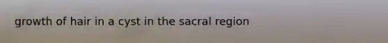 growth of hair in a cyst in the sacral region