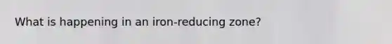 What is happening in an iron-reducing zone?