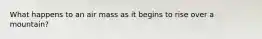 What happens to an air mass as it begins to rise over a mountain?