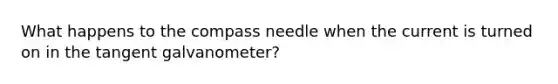 What happens to the compass needle when the current is turned on in the tangent galvanometer?