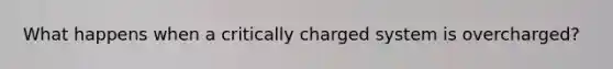 What happens when a critically charged system is overcharged?