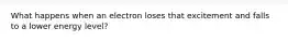 What happens when an electron loses that excitement and falls to a lower energy level?