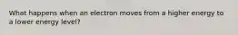 What happens when an electron moves from a higher energy to a lower energy level?