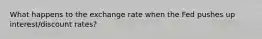 What happens to the exchange rate when the Fed pushes up interest/discount rates?