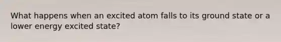 What happens when an excited atom falls to its ground state or a lower energy excited state?