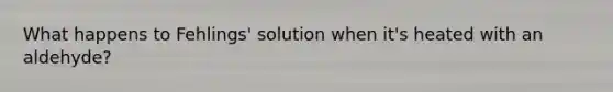 What happens to Fehlings' solution when it's heated with an aldehyde?