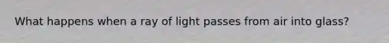 What happens when a ray of light passes from air into glass?