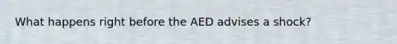 What happens right before the AED advises a shock?