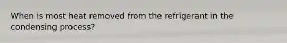 When is most heat removed from the refrigerant in the condensing process?