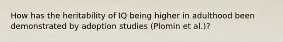 How has the heritability of IQ being higher in adulthood been demonstrated by adoption studies (Plomin et al.)?