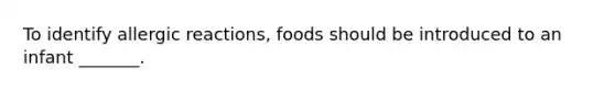 To identify allergic reactions, foods should be introduced to an infant _______.