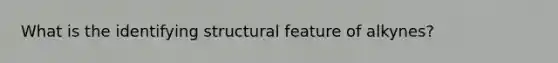 What is the identifying structural feature of alkynes?