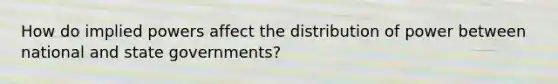 How do implied powers affect the distribution of power between national and state governments?