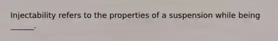 Injectability refers to the properties of a suspension while being ______.