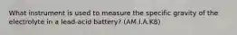 What instrument is used to measure the specific gravity of the electrolyte in a lead-acid battery? (AM.I.A.K8)