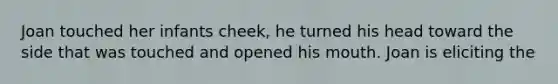 Joan touched her infants cheek, he turned his head toward the side that was touched and opened his mouth. Joan is eliciting the