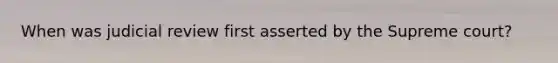When was judicial review first asserted by the Supreme court?
