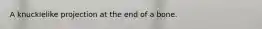 A knucklelike projection at the end of a bone.