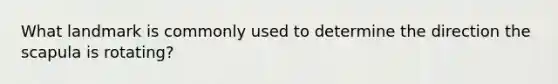What landmark is commonly used to determine the direction the scapula is rotating?