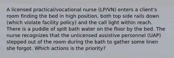 A licensed practical/vocational nurse (LP/VN) enters a client's room finding the bed in high position, both top side rails down (which violate facility policy) and the call light within reach. There is a puddle of spilt bath water on the floor by the bed. The nurse recognizes that the unlicensed assistive personnel (UAP) stepped out of the room during the bath to gather some linen she forgot. Which actions is the priority?