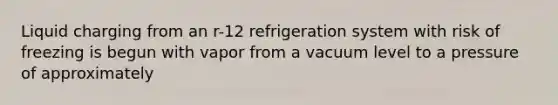 Liquid charging from an r-12 refrigeration system with risk of freezing is begun with vapor from a vacuum level to a pressure of approximately