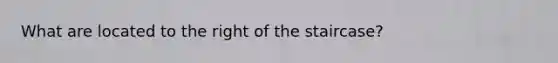 What are located to the right of the staircase?