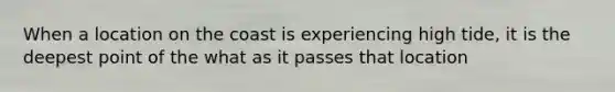 When a location on the coast is experiencing high tide, it is the deepest point of the what as it passes that location