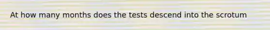 At how many months does the tests descend into the scrotum