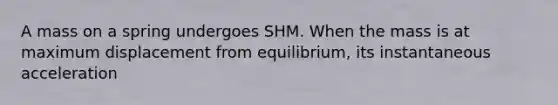 A mass on a spring undergoes SHM. When the mass is at maximum displacement from equilibrium, its instantaneous acceleration