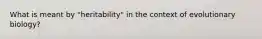 What is meant by "heritability" in the context of evolutionary biology?