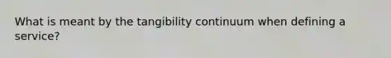 What is meant by the tangibility continuum when defining a service?