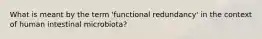 What is meant by the term 'functional redundancy' in the context of human intestinal microbiota?