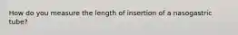 How do you measure the length of insertion of a nasogastric tube?