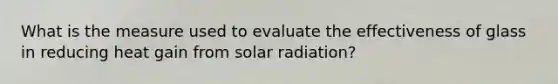 What is the measure used to evaluate the effectiveness of glass in reducing heat gain from solar radiation?