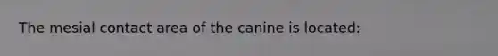 The mesial contact area of the canine is located: