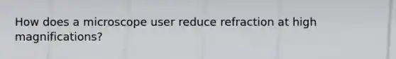 How does a microscope user reduce refraction at high magnifications?