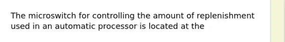 The microswitch for controlling the amount of replenishment used in an automatic processor is located at the