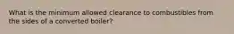 What is the minimum allowed clearance to combustibles from the sides of a converted boiler?