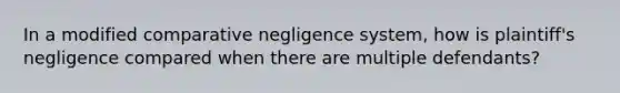 In a modified comparative negligence system, how is plaintiff's negligence compared when there are multiple defendants?