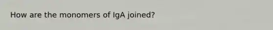 How are the monomers of IgA joined?