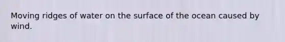 Moving ridges of water on the surface of the ocean caused by wind.