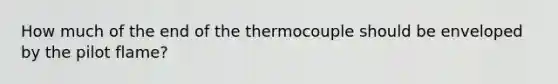 How much of the end of the thermocouple should be enveloped by the pilot flame?