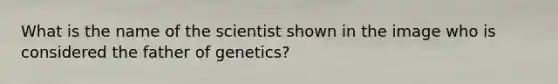 What is the name of the scientist shown in the image who is considered the father of genetics?