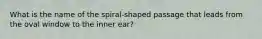 What is the name of the spiral-shaped passage that leads from the oval window to the inner ear?