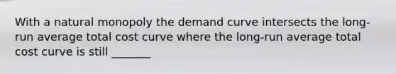 With a natural monopoly the demand curve intersects the long-run average total cost curve where the long-run average total cost curve is still _______