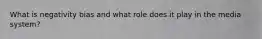 What is negativity bias and what role does it play in the media system?