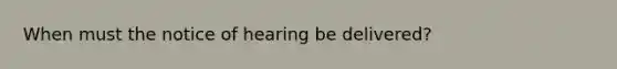 When must the notice of hearing be delivered?