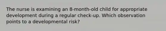 The nurse is examining an 8-month-old child for appropriate development during a regular check-up. Which observation points to a developmental risk?