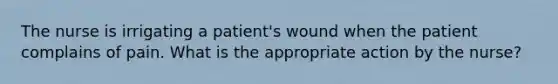 The nurse is irrigating a patient's wound when the patient complains of pain. What is the appropriate action by the nurse?